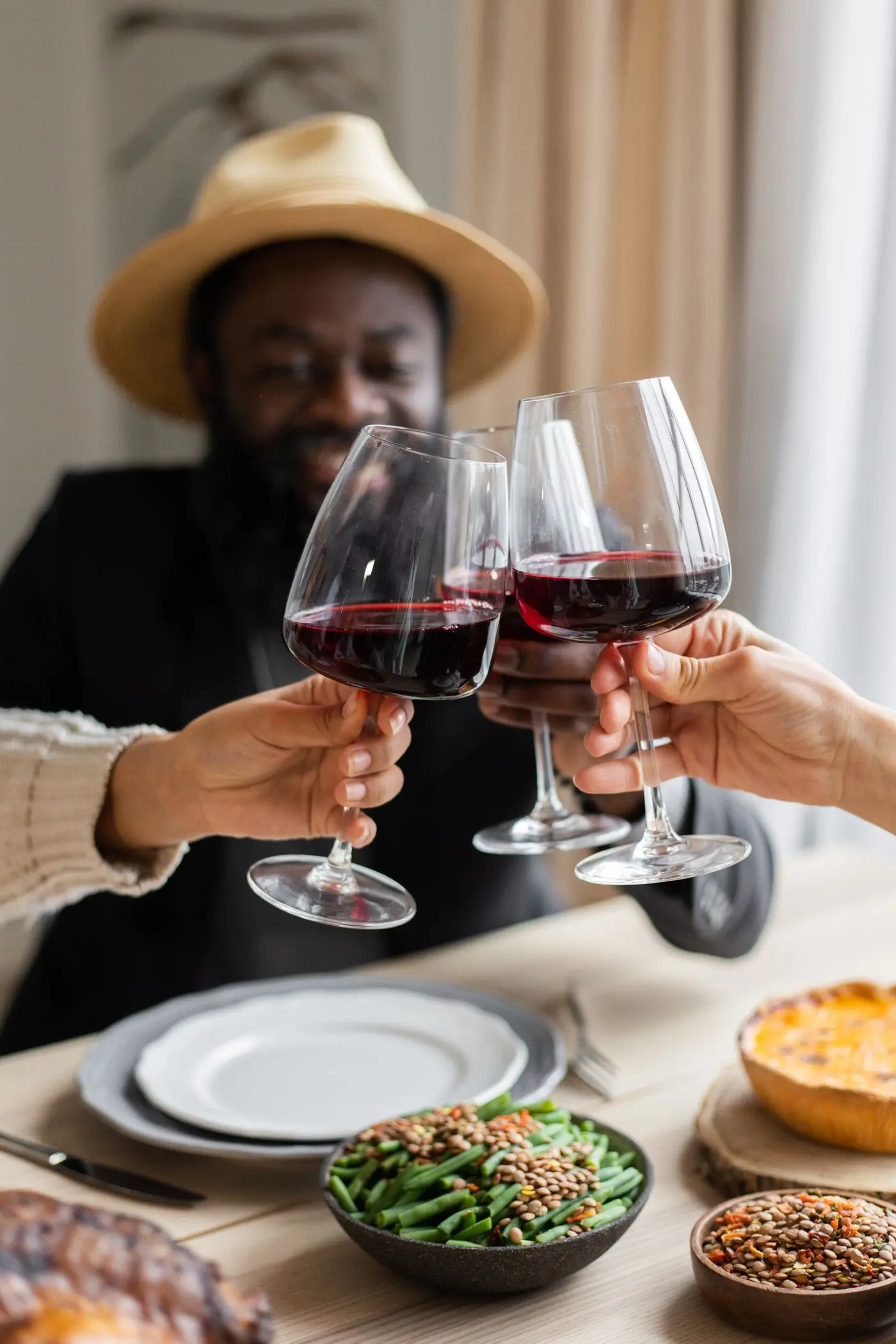 Guests raising glasses over a shared meal