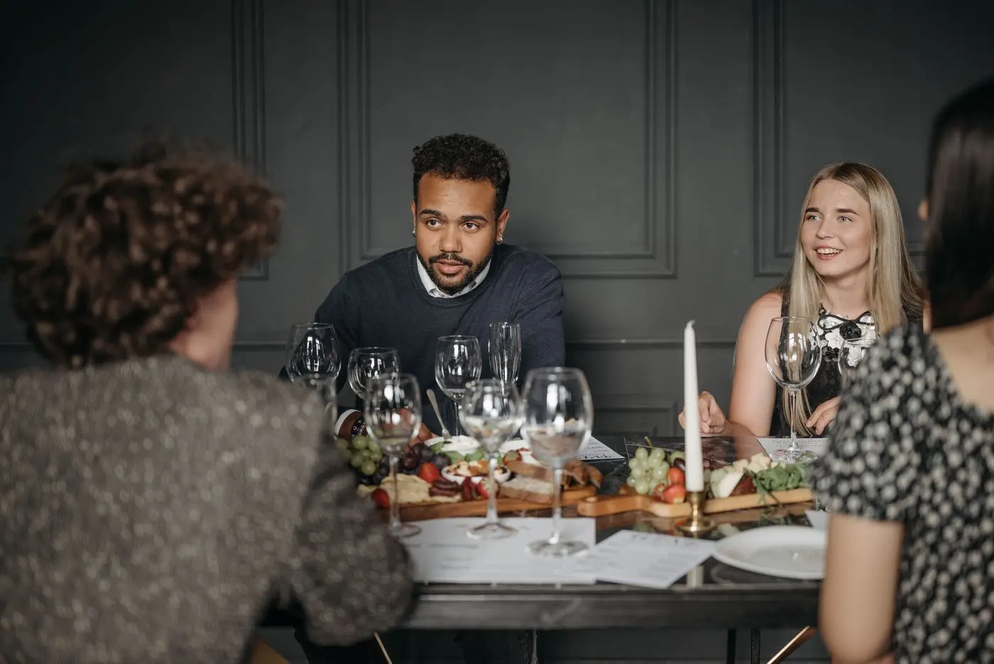 Guests talking together around a table with food and candles
