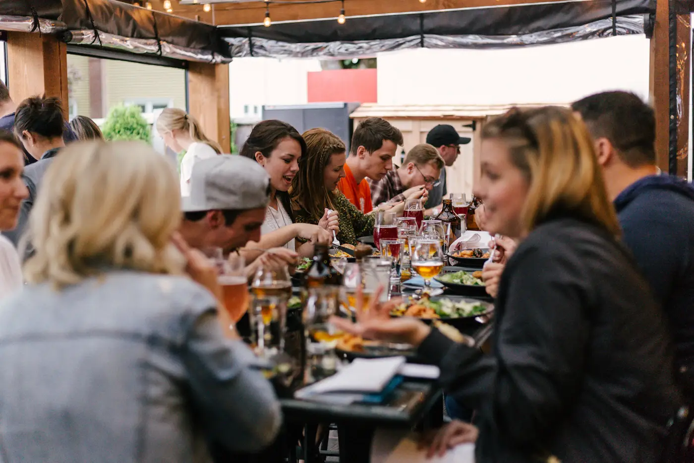 Guests talking over a shared meal at a long table