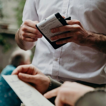 A waiter taking an order.