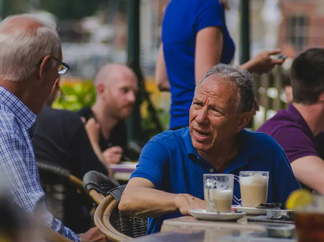 Two people sharing a conversation over a beverage